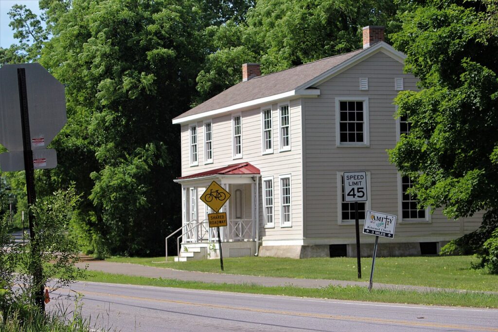 Two-story gray clapboard house with a small front porch along Vischer Ferry Road in Clifton Park, NY