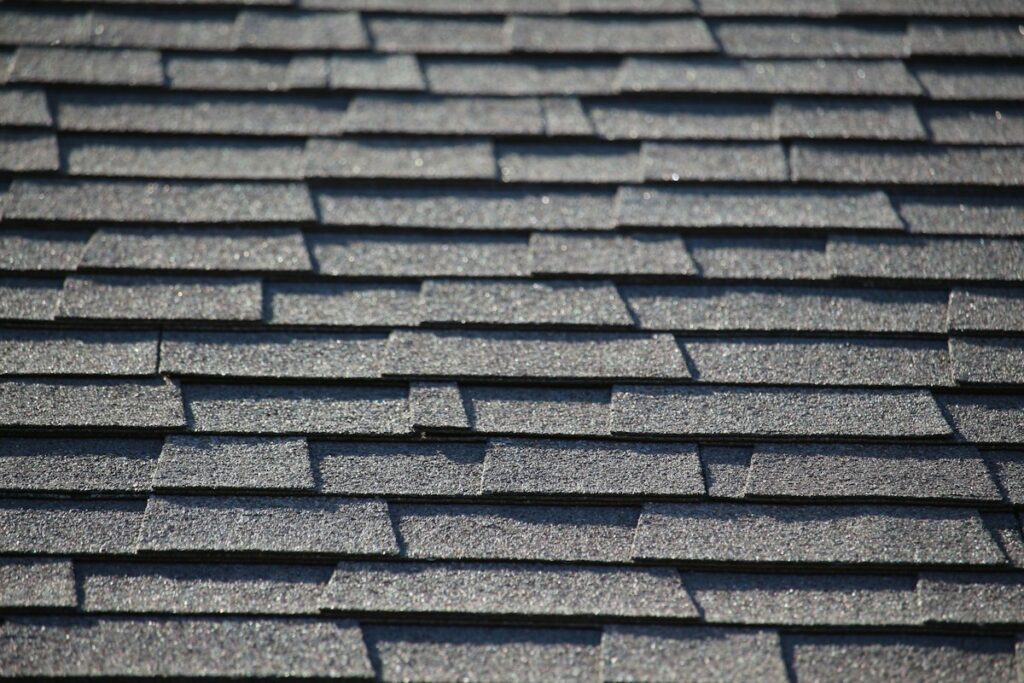 Close-up of gray architectural asphalt shingles on a pitched house roof